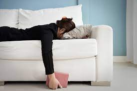 woman lying face down on couch