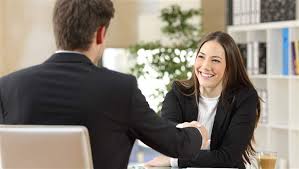 man and woman in suits shaking hands