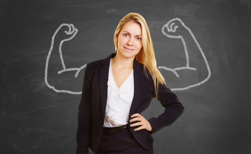business woman w/ large-muscled arms on chalkboard behind her