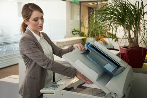 woman using a copier in an office