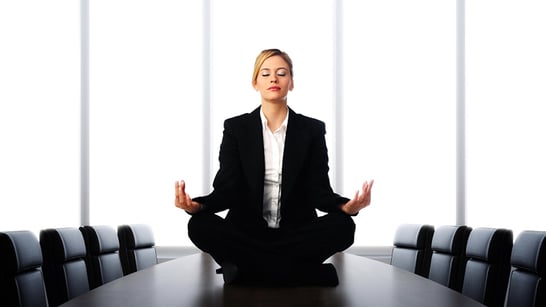 business woman in suit sitting on conference table